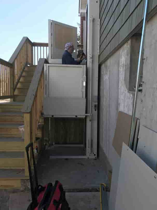 bruno platform lift being installed outside of long island home